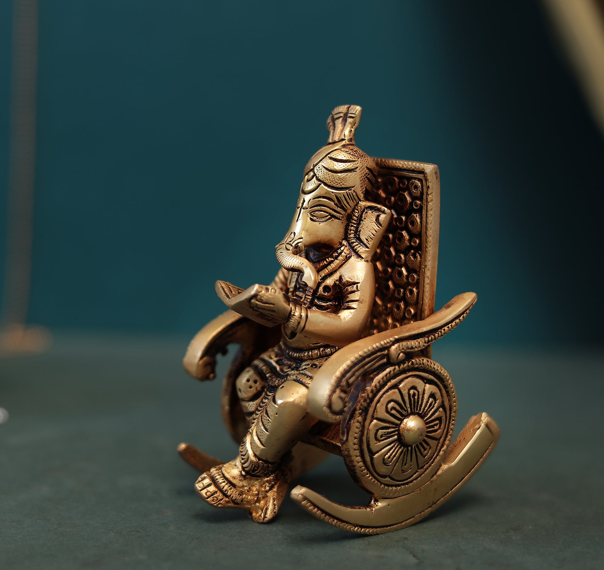 Superfine Reading Ganesha Sitting On Rocking Chair