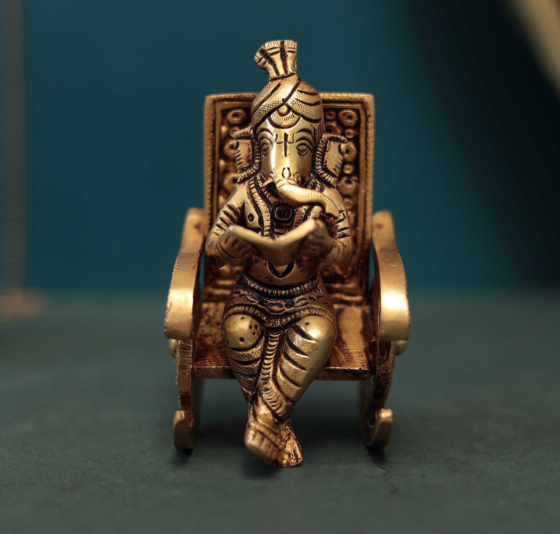 Superfine Reading Ganesha Sitting On Rocking Chair