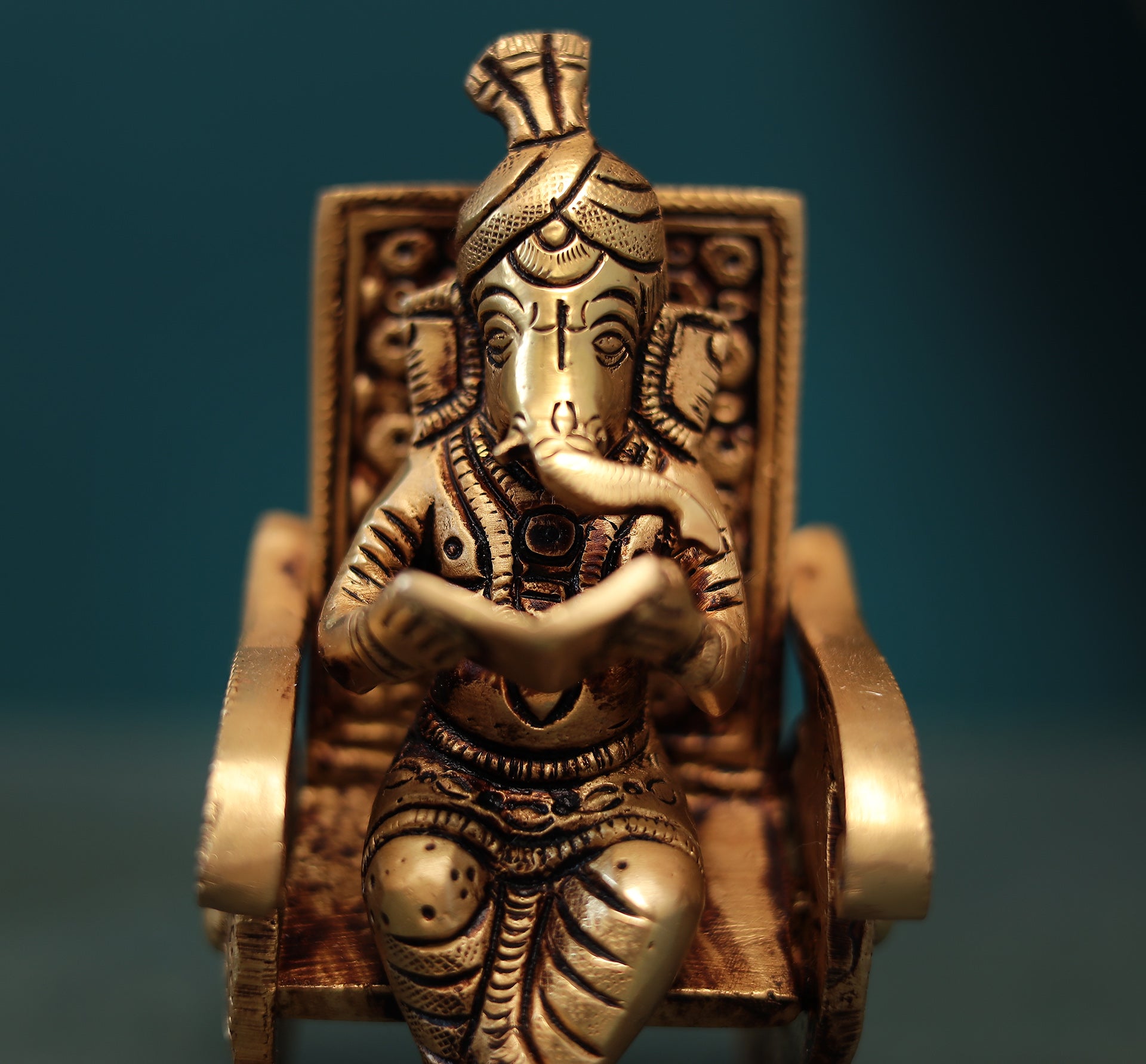 Superfine Reading Ganesha Sitting On Rocking Chair